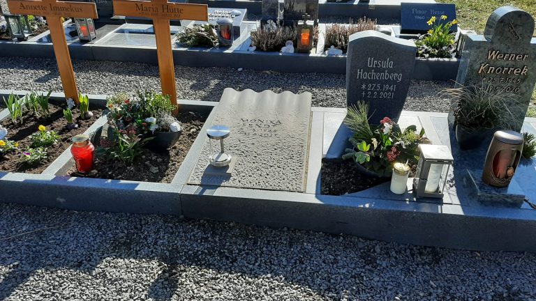 Urnen-Abdeckplatte mit plastischem Wellen-Motiv auf Steinmetzmäßig gearbeiteter Oberfläche mit genuteter Beschriftu