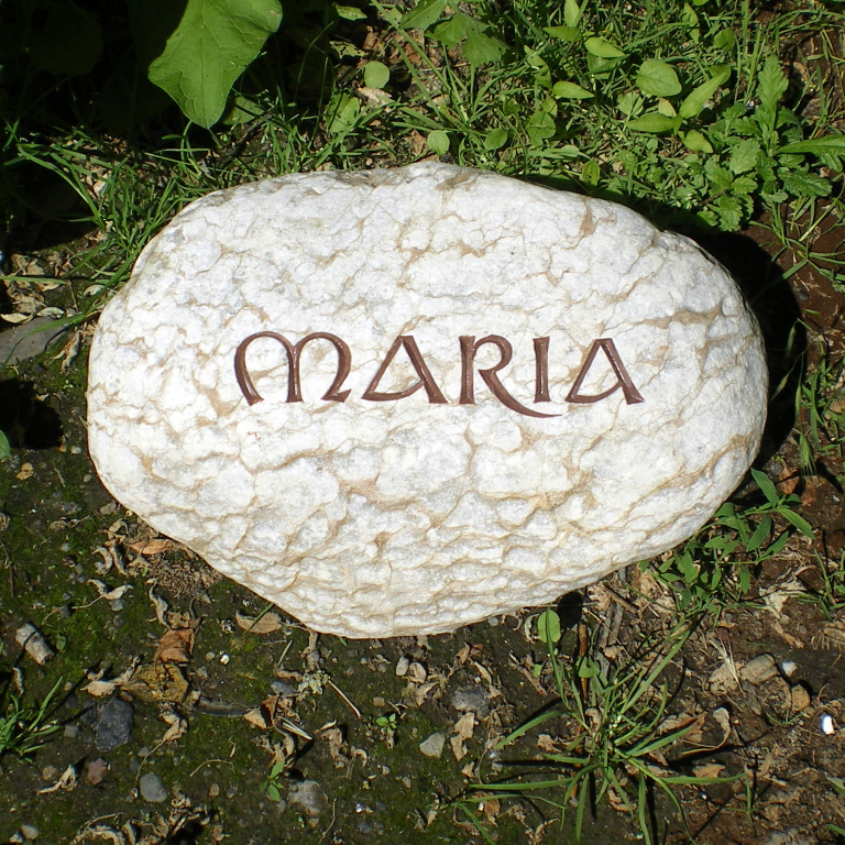 Beige marmorierter, weißer Findling-Grabstein, mit eingravierter  Unzialis-Schrift